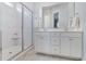 Bathroom with a walk-in shower, dual sinks, and white cabinets at 1756 Timmons St, Mount Pleasant, SC 29466