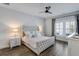 Bedroom featuring a tufted headboard, neutral tones, and ample natural light from shuttered windows at 1756 Timmons St, Mount Pleasant, SC 29466