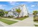 Beautiful two-story home with well-maintained lawn, palm trees, and a detached garage at 1756 Timmons St, Mount Pleasant, SC 29466
