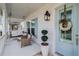 Inviting front porch featuring a swing, seating, stylish decor, and charming blue door at 1756 Timmons St, Mount Pleasant, SC 29466