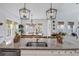 Kitchen island featuring granite countertops, stainless steel appliances, and an open dining area at 1756 Timmons St, Mount Pleasant, SC 29466
