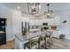 Bright kitchen featuring white cabinets, stainless steel appliances, a granite island, and pendant lighting at 1756 Timmons St, Mount Pleasant, SC 29466