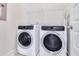Laundry room featuring white washer and dryer units with overhead shelving for storage at 1756 Timmons St, Mount Pleasant, SC 29466
