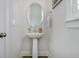 Powder room featuring a pedestal sink, oval mirror and neutral tones at 1756 Timmons St, Mount Pleasant, SC 29466