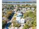 Aerial view features the home's light colored siding and the surrounding waterway and neighborhood at 18 Wills Way, Isle of Palms, SC 29451