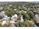 Aerial view shows the homes light colored siding and roof within a coastal neighborhood at 18 Wills Way, Isle of Palms, SC 29451