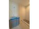 Bathroom with modern gray cabinets, hexagon floor tiles, and a shower with white tiled walls and a built-in niche at 18 Wills Way, Isle of Palms, SC 29451