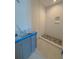 A bathroom with modern gray cabinets, hexagon floor tiles, and a shower with white tiled walls and a built-in niche at 18 Wills Way, Isle of Palms, SC 29451