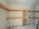 Walk-in closet featuring custom built in wood shelving and organization at 18 Wills Way, Isle of Palms, SC 29451