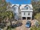 The exterior of the charming new construction home features an elevated foundation and steps to the front door at 18 Wills Way, Isle of Palms, SC 29451