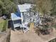 A rear view of the home under construction showcases a spacious covered patio and an outdoor shower at 18 Wills Way, Isle of Palms, SC 29451