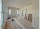 Living room with wainscotting throughout featuring lots of natural light from three windows at 18 Wills Way, Isle of Palms, SC 29451