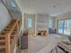 Spacious living room with fireplace featuring new sliding glass doors and stairs at 18 Wills Way, Isle of Palms, SC 29451