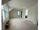 Room with large windows, sloped ceilings, neutral walls, and doors, and a peek at a bathroom at 18 Wills Way, Isle of Palms, SC 29451