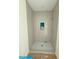 Contemporary shower with gray tiling, a niche and mosaic flooring at 18 Wills Way, Isle of Palms, SC 29451