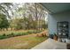 View of the trees and landscape from the covered patio of this beautiful blue home at 1818 Orangeburg St, North Charleston, SC 29405