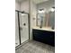 Bathroom showcasing a tiled shower, double vanity, and patterned tile flooring at 1818 Orangeburg St, North Charleston, SC 29405
