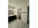 Well-lit bathroom featuring double vanity with black cabinets and black and white patterned tile flooring at 1818 Orangeburg St, North Charleston, SC 29405