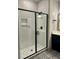 Bathroom featuring an enclosed tiled shower with black trim and black and white patterned tile flooring at 1818 Orangeburg St, North Charleston, SC 29405