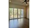 Bright and airy bedroom featuring sliding glass doors leading to a balcony, hardwood floors, and natural light at 1818 Orangeburg St, North Charleston, SC 29405