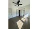 Bright bedroom with hardwood floors, ceiling fan, and closet and bathroom doors at 1818 Orangeburg St, North Charleston, SC 29405