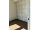 Empty bedroom with wood floors and patterned wallpaper on the wall at 1818 Orangeburg St, North Charleston, SC 29405