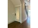 Entryway with hardwood floors, stairs with black railing, a white door, and neutral-colored walls at 1818 Orangeburg St, North Charleston, SC 29405