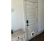 Hallway with white door that has a pet door and modern baseboard and door frame trim detail at 1818 Orangeburg St, North Charleston, SC 29405