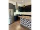 Modern kitchen with stainless steel appliances, granite countertops, island with custom black and white tiling at 1818 Orangeburg St, North Charleston, SC 29405