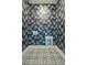 Unique laundry room featuring patterned tile flooring and fun celestial starburst wallpaper at 1818 Orangeburg St, North Charleston, SC 29405