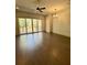 Bright living room with wood floors, ceiling fan, and sliding glass doors to the balcony at 1818 Orangeburg St, North Charleston, SC 29405