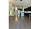 Open living space with wood floors and stainless steel appliances in the kitchen area at 1818 Orangeburg St, North Charleston, SC 29405