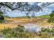 Picturesque marsh view with blue skies, tall grasses, and a single Great Egret wading in the water at 1818 Orangeburg St, North Charleston, SC 29405