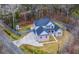 Aerial view of home showcasing the roof, surrounding landscape, and large paved driveway leading to the property at 1880 Bacons Bridge Rd, Summerville, SC 29485