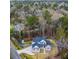 Aerial view of home surrounded by a wooded area showcasing a well-maintained yard and long paved driveway at 1880 Bacons Bridge Rd, Summerville, SC 29485