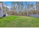 Green backyard is fully fenced and surrounded by mature trees for privacy and shade on warm days at 1880 Bacons Bridge Rd, Summerville, SC 29485