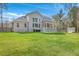 Expansive backyard features a well-maintained lawn, exterior shed, and a covered porch with ceiling fans at 1880 Bacons Bridge Rd, Summerville, SC 29485