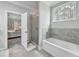 Modern bathroom featuring a soaking tub, tiled shower, and view of the main bedroom at 1880 Bacons Bridge Rd, Summerville, SC 29485