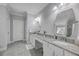 Bathroom featuring dual sinks, granite countertops, a vanity area, and a large mirror at 1880 Bacons Bridge Rd, Summerville, SC 29485