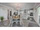 Charming dining area with a stylish chandelier, elegant chairs, and a view of the modern kitchen at 1880 Bacons Bridge Rd, Summerville, SC 29485