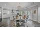Bright dining area with chic seating and lighting, complemented by an open view to the patio at 1880 Bacons Bridge Rd, Summerville, SC 29485