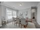 Elegant dining room with hardwood floors, neutral décor, and a wooden table set for six at 1880 Bacons Bridge Rd, Summerville, SC 29485
