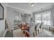 Elegant dining room with hardwood floors, neutral décor, and a wooden table set for six at 1880 Bacons Bridge Rd, Summerville, SC 29485