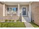 Inviting front porch with stylish decor, including a welcome sign and cozy seating area at 1880 Bacons Bridge Rd, Summerville, SC 29485
