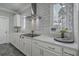 A closer view of the kitchen with quartz countertops, stainless steel vent hood and herringbone backsplash at 1880 Bacons Bridge Rd, Summerville, SC 29485