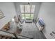 Spacious living room with hardwood floors, ample seating, and floor-to-ceiling windows offering scenic views at 1880 Bacons Bridge Rd, Summerville, SC 29485