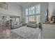 Spacious living room with high ceilings, ample windows, and stylish gray furnishings at 1880 Bacons Bridge Rd, Summerville, SC 29485