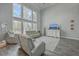 Inviting living room with tall windows, comfortable seating, and a stylish console with decor at 1880 Bacons Bridge Rd, Summerville, SC 29485