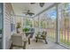 Outdoor porch featuring comfortable wicker seating, a ceiling fan, and a view of the surrounding nature at 1880 Bacons Bridge Rd, Summerville, SC 29485