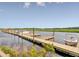 A long wooden boat dock is equipped with multiple boat slips and a few boats are docked on the water at 2008 Stonebraker Ln, Hanahan, SC 29410